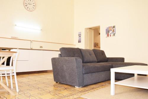 a living room with a couch and a table at Valletta Mint Apartment 1 in Valletta