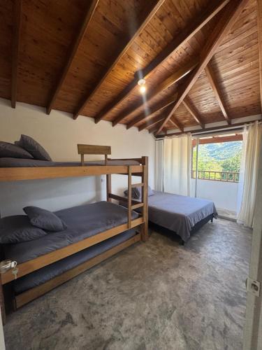 two bunk beds in a room with a window at La torrecita in Barbosa