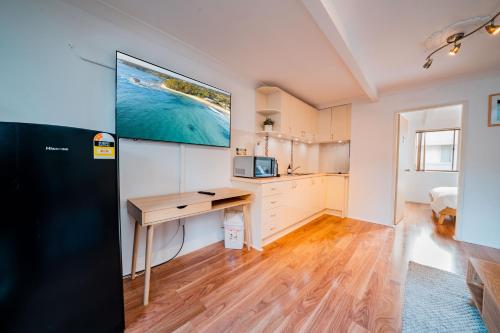 a kitchen with a desk and a computer in a room at Mollymook Beach getaway in Mollymook
