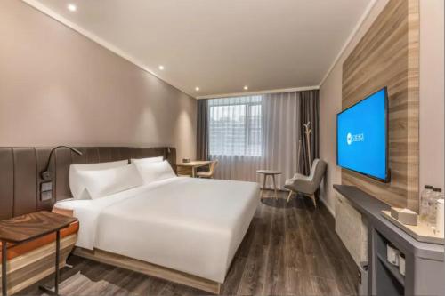 Ένα ή περισσότερα κρεβάτια σε δωμάτιο στο Hanting Premium Hotel Shanghai West Yingao Road Subway Station