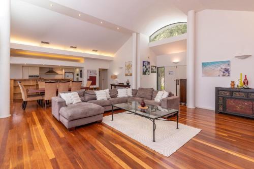 a living room with a couch and a table at Karingal just minutes from Blueys Beach in Charlotte Bay