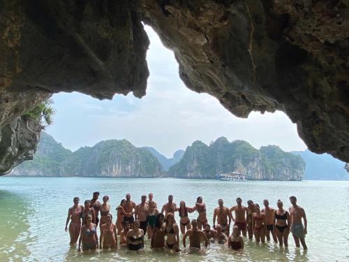 a group of people in the water in a cave at CATBA PANDORA Hotel & Travel in Cat Ba