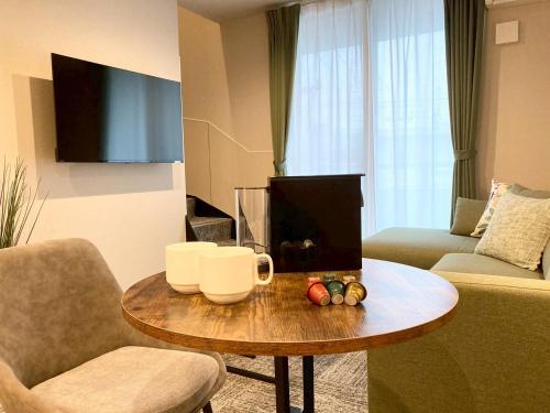 a living room with a coffee table and a couch at Liaison Court Nishikujo Universal Bay 2 in Osaka