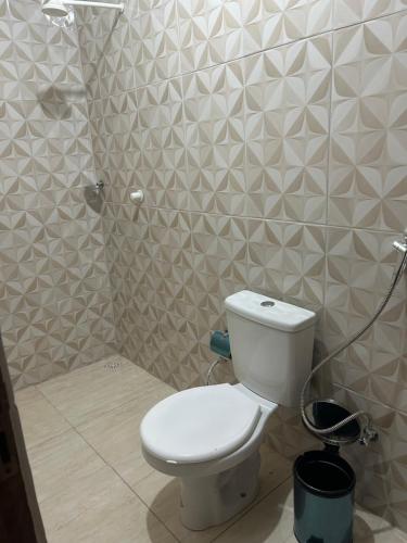 a bathroom with a toilet and a shower at Casa Tunel in Pôrto de Pedras