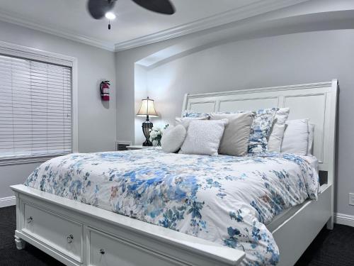 a bedroom with a bed with a blue and white comforter at Destination #28 in Anaheim