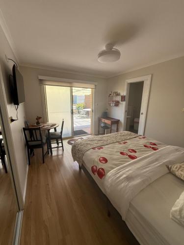 Un dormitorio con una cama y una mesa y un comedor. en Montrose holiday cottage, en Rosetta