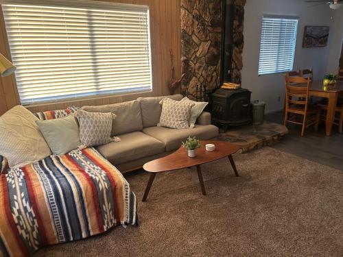 a living room with a couch and a coffee table at Peaceful Big Bear Cabin in Baldwin Lake