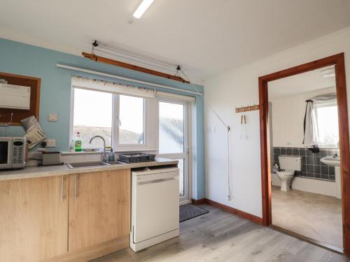 a kitchen with a sink and a toilet in a bathroom at Arnaval in Fernilea