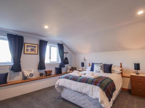 a bedroom with a large bed with blue curtains at Arnaval in Fernilea