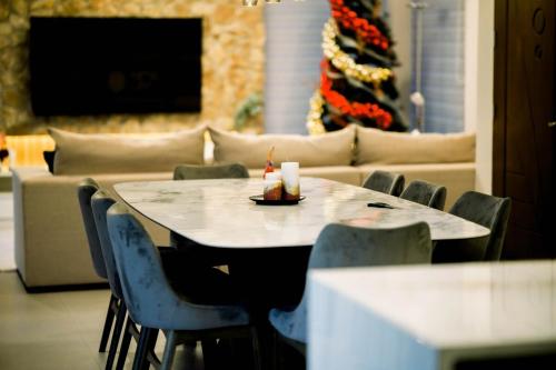 a table and chairs in a room with a couch at Villa 360 in Calaca