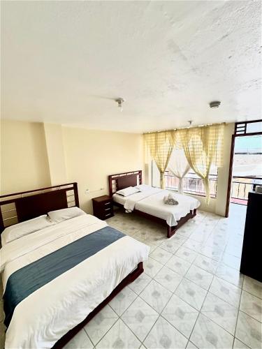 Postel nebo postele na pokoji v ubytování Hostal Copacabanna