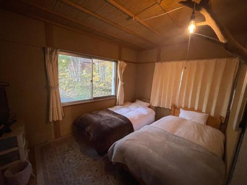 Ένα ή περισσότερα κρεβάτια σε δωμάτιο στο グリーンハウス