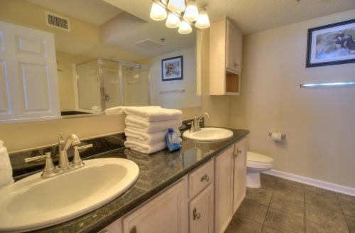 a bathroom with two sinks and a toilet at Crescent Shores South - 510 in Myrtle Beach