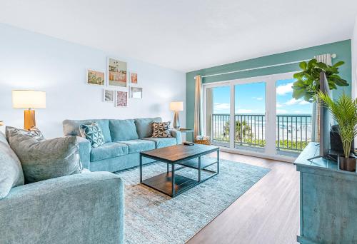 a living room with a couch and a table at Boardwalk 205 in Cocoa Beach