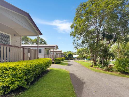 a house with a walkway next to a house at Atherton Tourist Park in Atherton