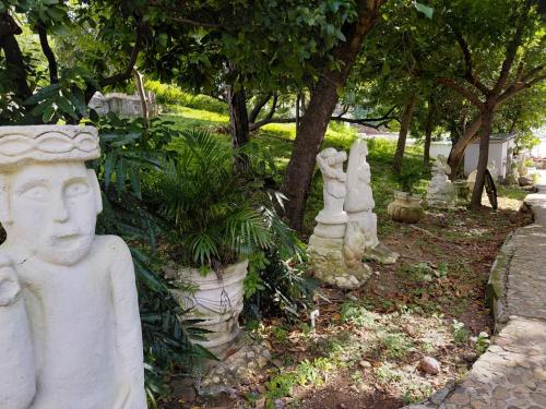 a group of statues in a garden with trees at El Remanso Hotel y Restaurante in Rivas