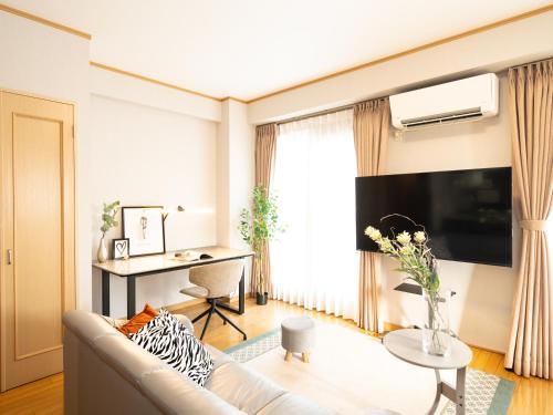 a living room with a couch and a table at The Global West in Niihama