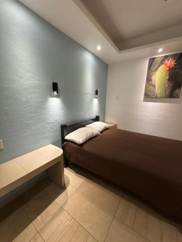 a bedroom with a bed and a painting on the wall at Hotel Real Mixteca in Huajuapan de León