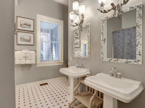 a bathroom with two sinks and a mirror at Southern Hall Lower in Savannah