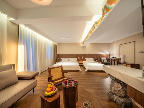 a hotel room with two beds and a living room at Nan she in Datong