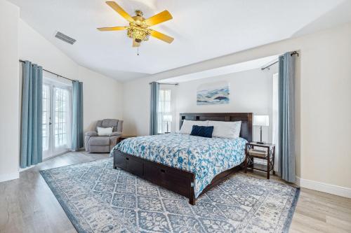 a bedroom with a bed and a ceiling fan at 601 Benedictine Ter in Sebastian