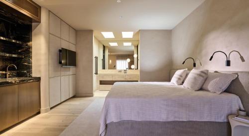 a bedroom with a large bed and a bathroom at The Sanctuary at Alba Thermal Springs & Spa in Fingal