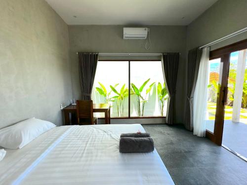 Una cama o camas en una habitación de Mutiara Homestay Uluwatu