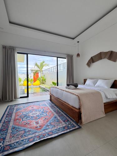 a bedroom with a bed and a large rug at Aloka Villa -Stylish 2 bedroom villa in the heart of Seseh in Munggu