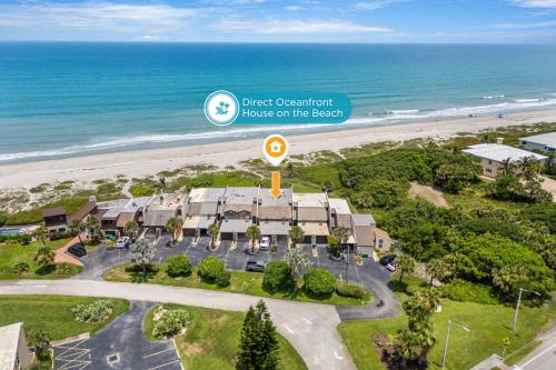 an aerial view of a resort with a beach at 1045 Wave Crest Avenue in Indialantic