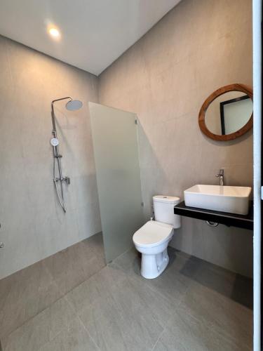 a bathroom with a toilet and a sink at Aloka Villa -Stylish 2 bedroom villa in the heart of Seseh in Munggu