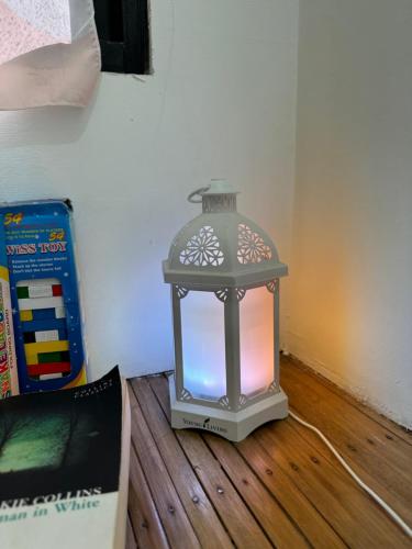 a lantern sitting on top of a wooden floor at Beach Side Cabin San Juan ELYU in San Juan