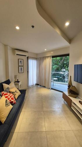 a large living room with a couch and a television at Tambuli Resort & Spa Mactan Cebu Full Resort Access B2C Condo in Lapu Lapu City