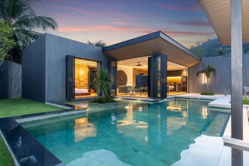 a swimming pool in front of a house at Cocoon Villa 5 - Luxurious 3BR Pool Retreat near Naithon Beach in Nai Thon Beach