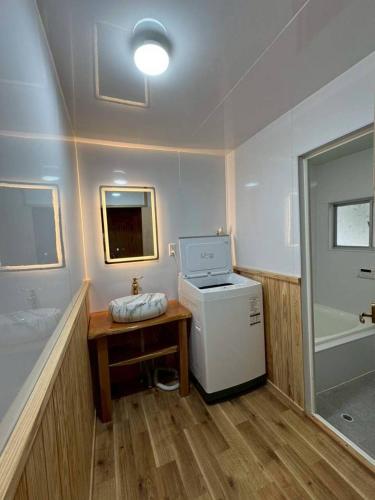 a laundry room with a washer and dryer in it at Seasid830 in Kuranomoto