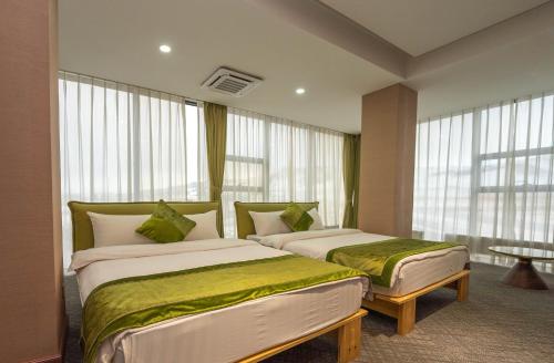 Ένα ή περισσότερα κρεβάτια σε δωμάτιο στο Amgun Hotel Ulaanbaatar