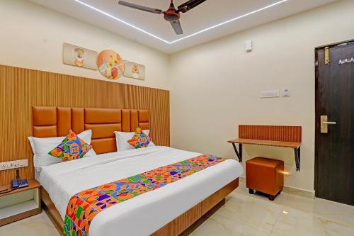 a bedroom with a large bed and a desk at Hotel RA Apartment in Chennai
