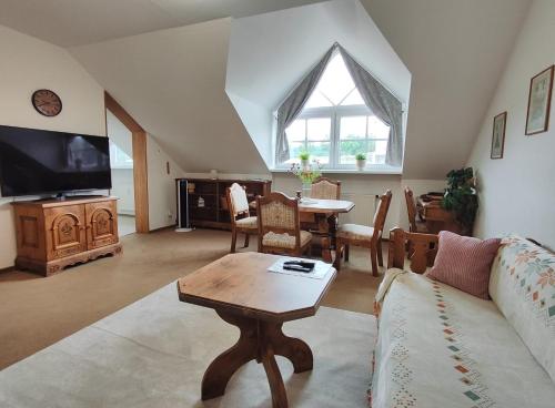 a living room with a couch and a table at Kurpark Suite in Bad Rodach