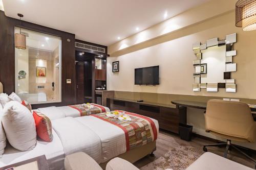 a hotel room with two beds and a desk at Siddhartha Diyalo in Bīrganj