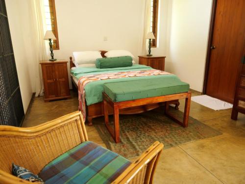 a bedroom with a bed and a table and chairs at The Heights in Asgiriya in Kandy