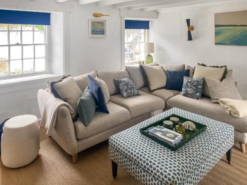 a living room with a couch and a table at Shearwaters in Saint Mawes