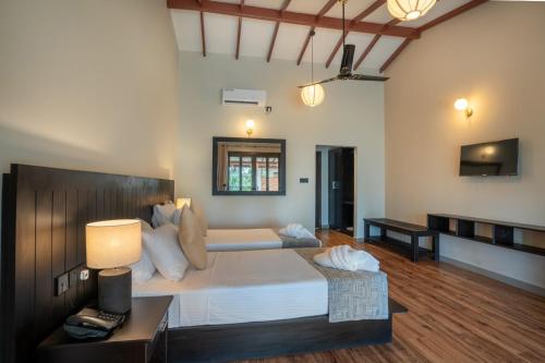 une chambre avec un grand lit dans une pièce dans l'établissement Lavendish Beach Resort, à Unawatuna