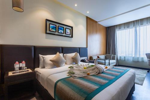 a hotel room with a bed and a chair at Siddhartha Diyalo in Bīrganj