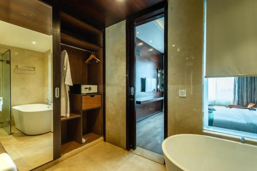 a bathroom with a bath tub and a bedroom at Siddhartha Diyalo in Bīrganj