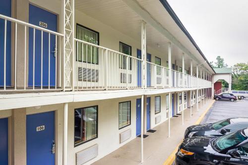 a building with cars parked in a parking lot at Motel 6-Gainesville, GA in Gainesville