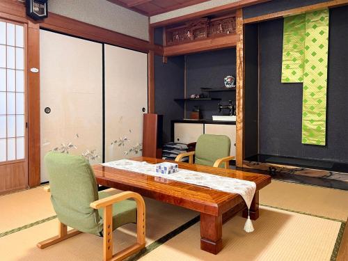 a dining room with a table and two chairs at ゲストハウスサンテ in Susaki