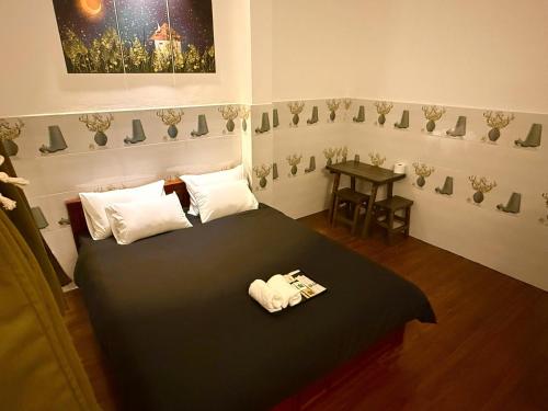 a bedroom with a large black bed with white pillows at ấm iu Hotel in Ho Chi Minh City