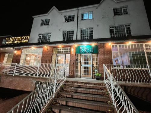 a building with stairs in front of a building at White Rose Hotel & Restaurant - Leeds in Leeds