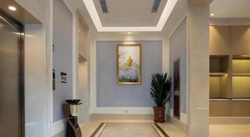 a hallway of a building with a painting on the wall at Vienna Hotel Beijing Changping Science and Technology Park in Changping
