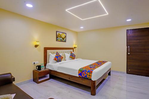 1 dormitorio con 1 cama grande y puerta de madera en Hotel OP Palace, en Colva