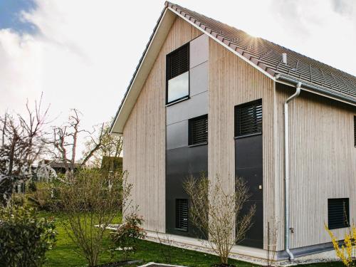 a house with a large window on the side of it at Ferienhausträume Oase Bodensee in Kreuzlingen